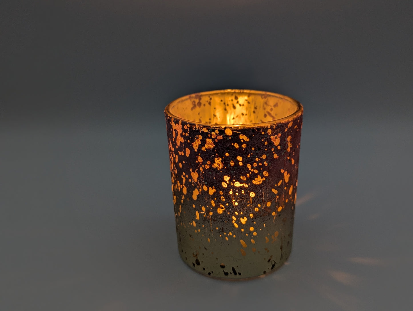 Kleines Glaswindlicht rosa-gold Nahaufnahme dekorative Beleuchtung mit brennendem Teelicht